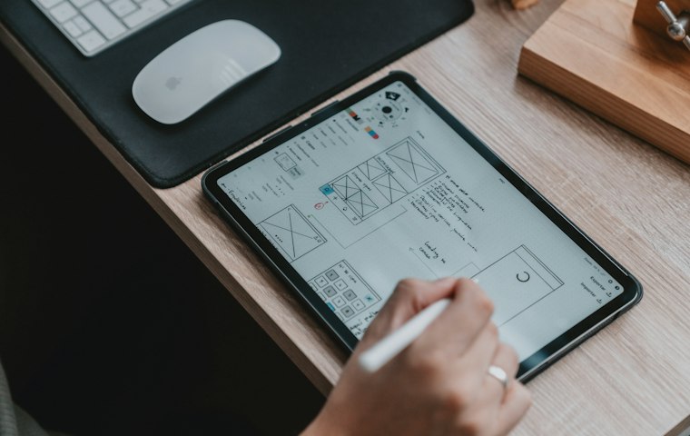 Designer sketching a website wireframe on a tablet